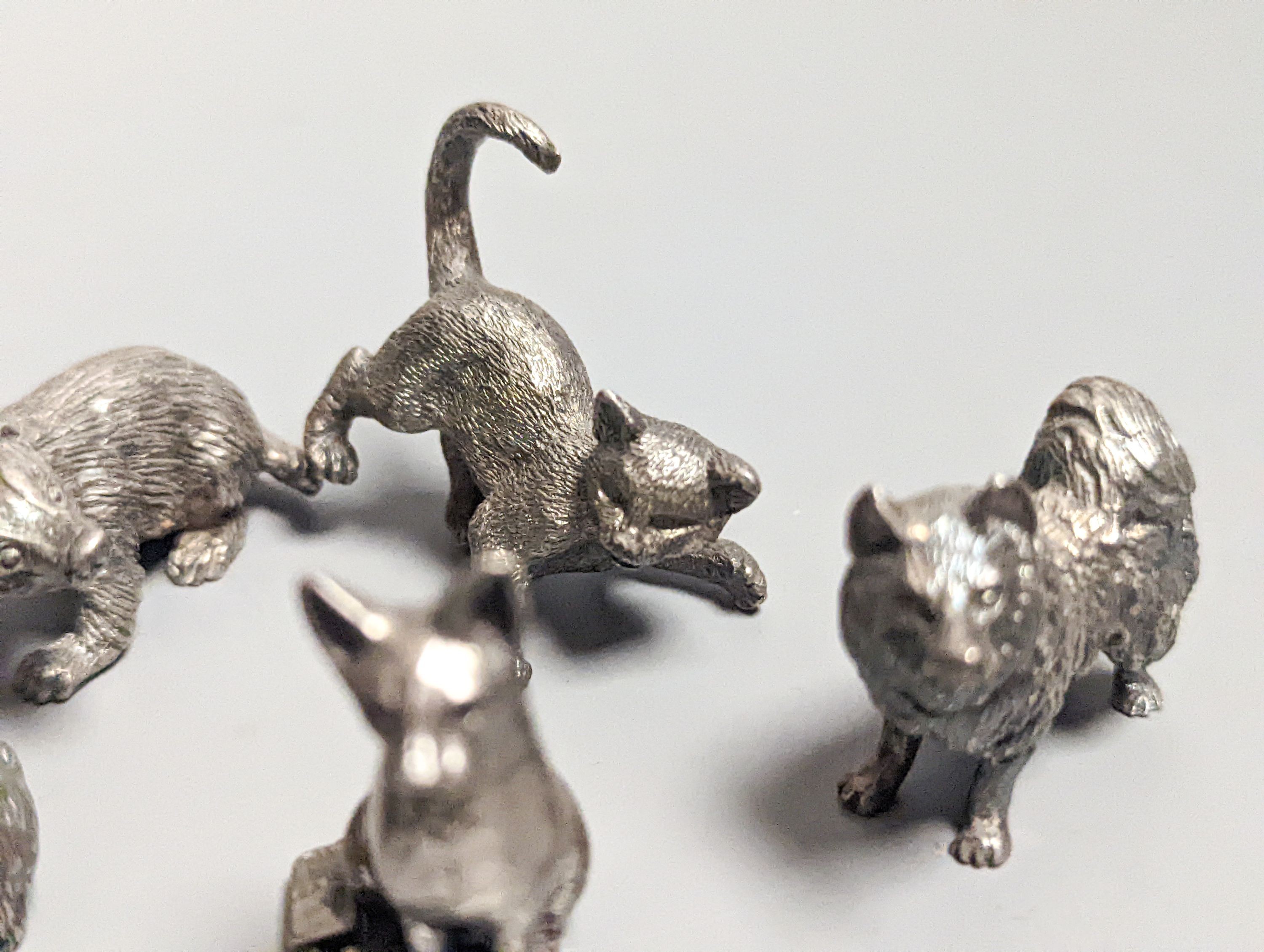 Four modern miniature freestanding model animals, including, badger, two dogs and a cat, JJSM, London, 1989 &1991, cat length 37mm, two Italian 925 models and two base metal models.